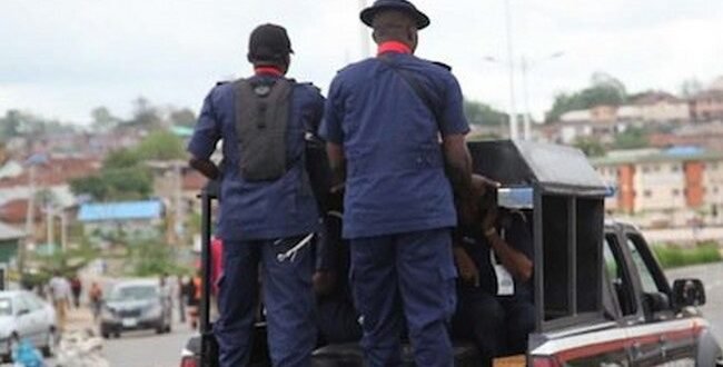 Nscdc illegal mining site, taking a dredging machine in Anambra